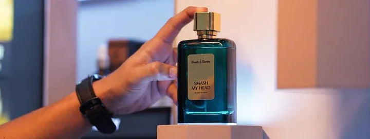 A hand touches the Smash My Head bottle, showing the presentation of a Scentories fragrance when considering how should I choose a perfume for myself.